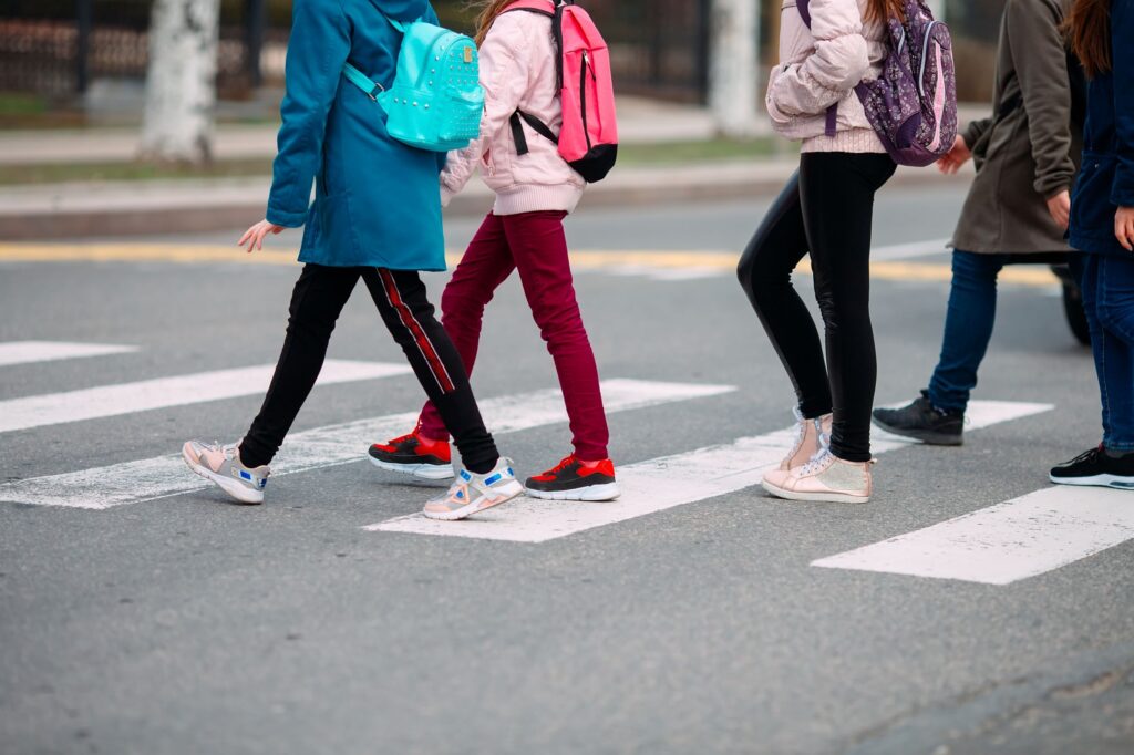 Children walking to school and crossing the street