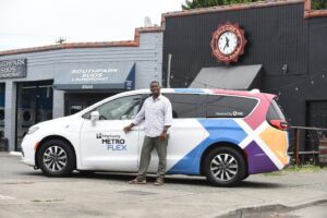 Image of a man standing in front of the Metro Flex van
